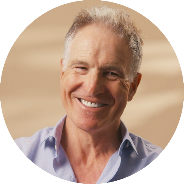 Close-up of Professor Mark Johnson smiling against a warm background.