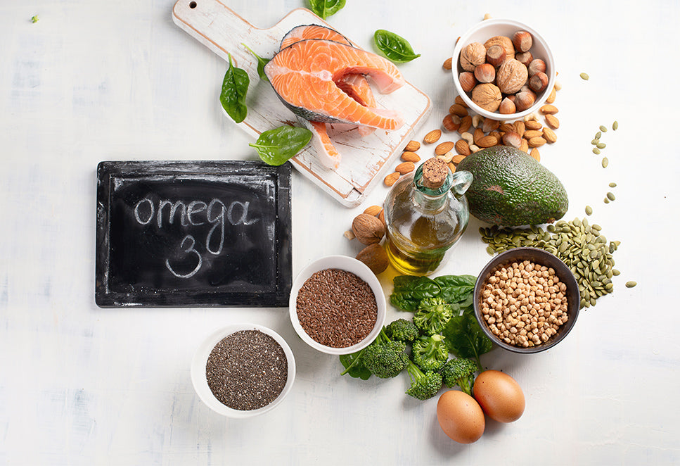 Collection of omega-3 rich foods on a marble surface. 