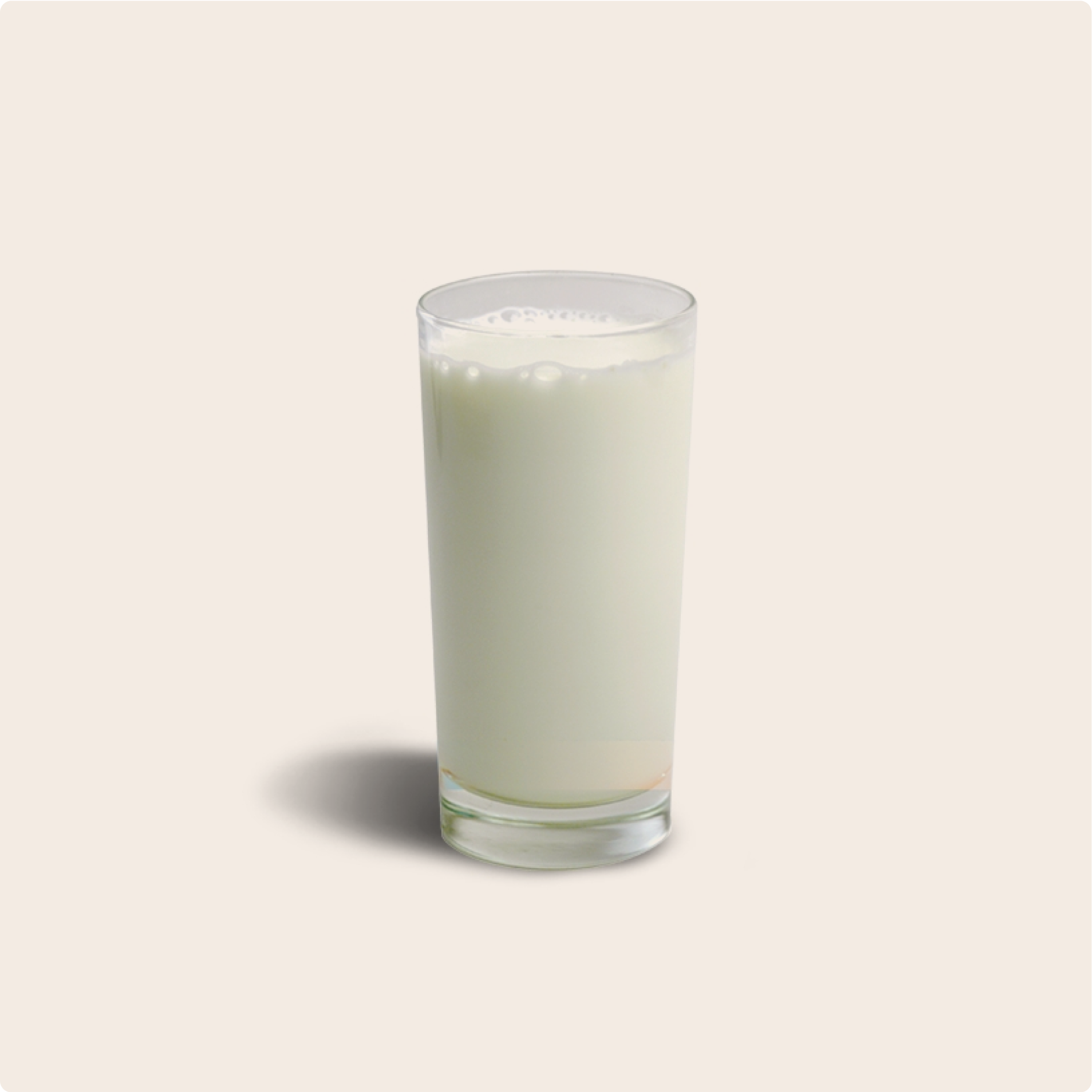 Full glass of milk, on a plain cream background, high in calcium