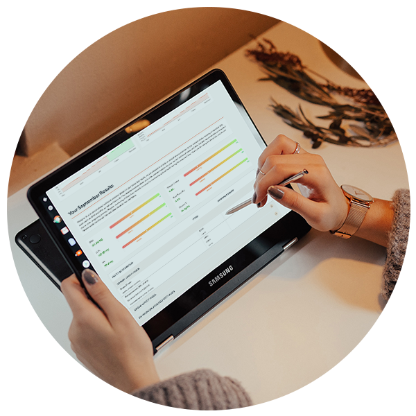 Close up of female hands holding a tablet computer, with data graphs on the screen. 