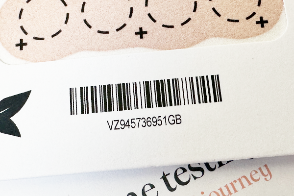 Close-up of the Nurture blood testing kit and a barcode and text.