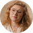 Round headshot of Roxanne Bakker, Nurture Nutritionist, wearing glasses with wavy hair on a beige background