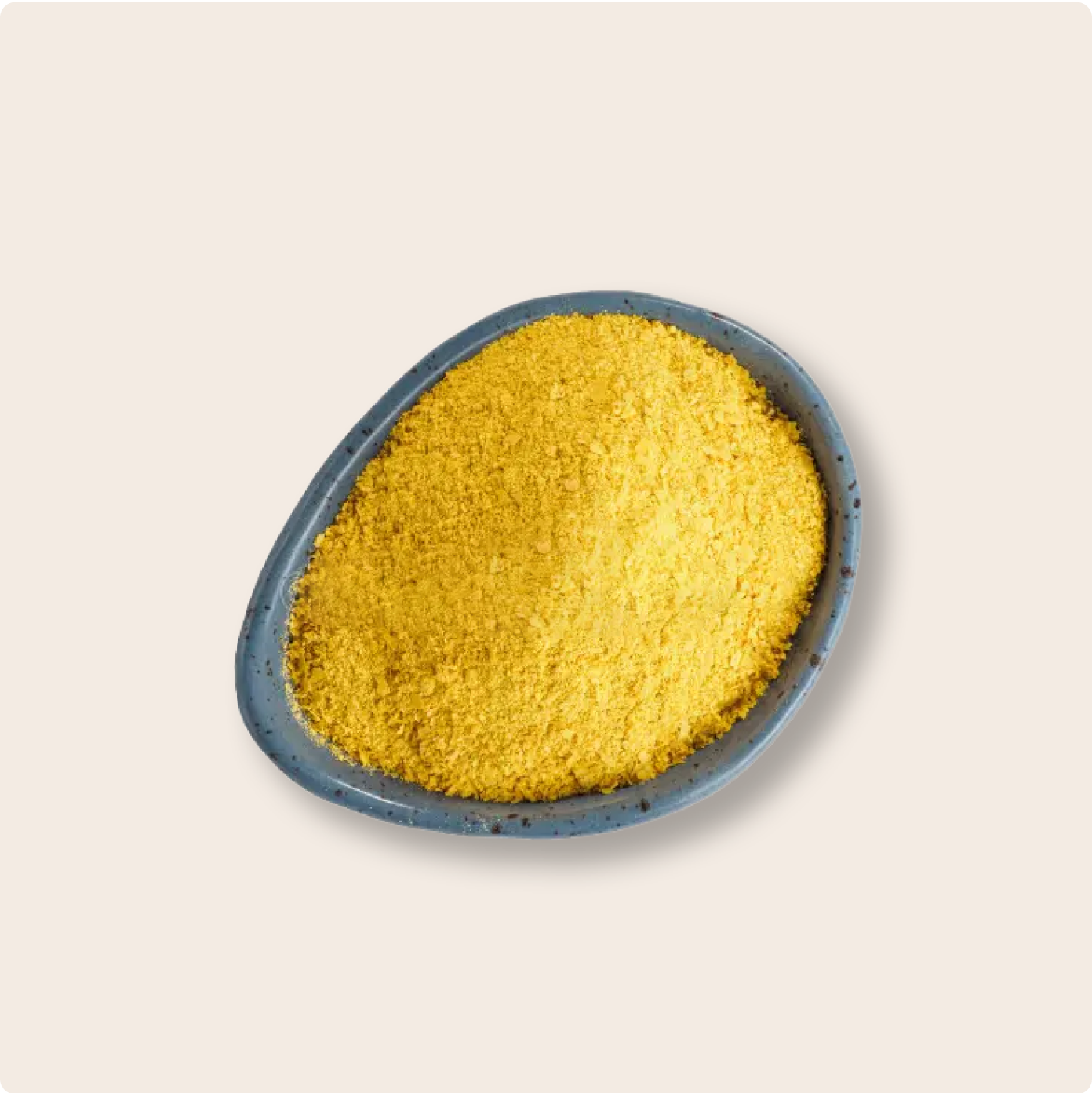 Plate of nutritional yeast against a cream background. 